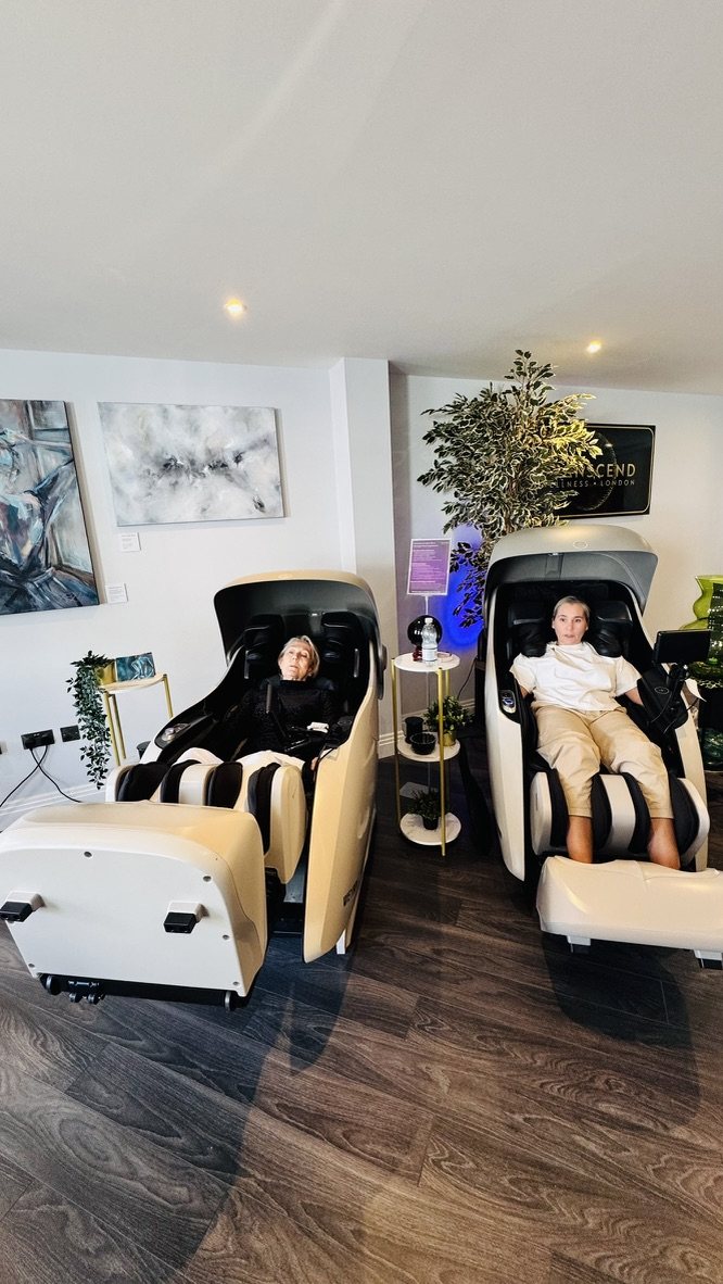 Two clients side by side in the massage chairs at Transcend